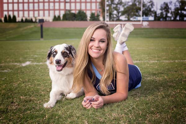 High School Senior Cheerleader Laying with Dog in Franklin | Sports Senior Portraits Moments By T
