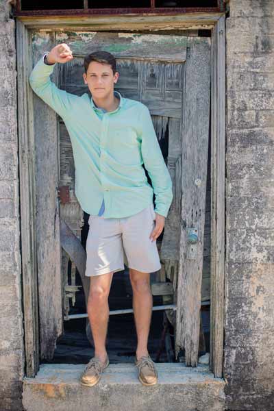 Senior Boy Standing In A Barn Doorway in Franklin TN | Senior Portraits Moments By T